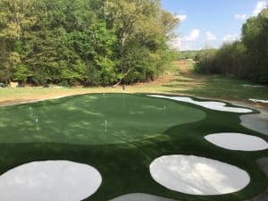 artificial grass putting green with multiple sand bunkers