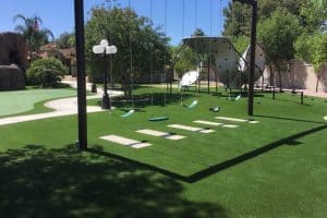 large backyard artificial grass lawn with swingset