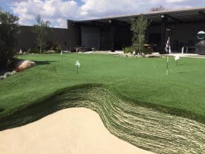 backyard putting green with stacked sod bunker
