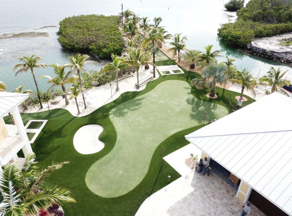Overhead view of Florida synthetic turf putting green with bunker on ocean
