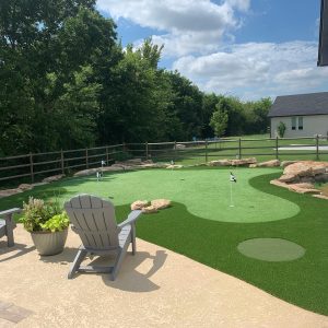 beautiful backyard with custom putting green