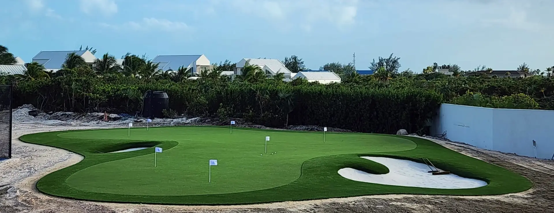 custom putting green with white sand bunkers