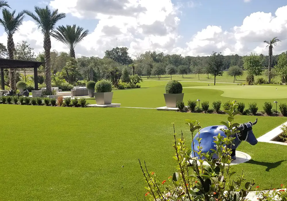Artificial grass lawn and landscaped putting area at a private ranch in Houston, Texas
