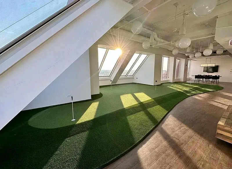 An indoor putting green inside a home