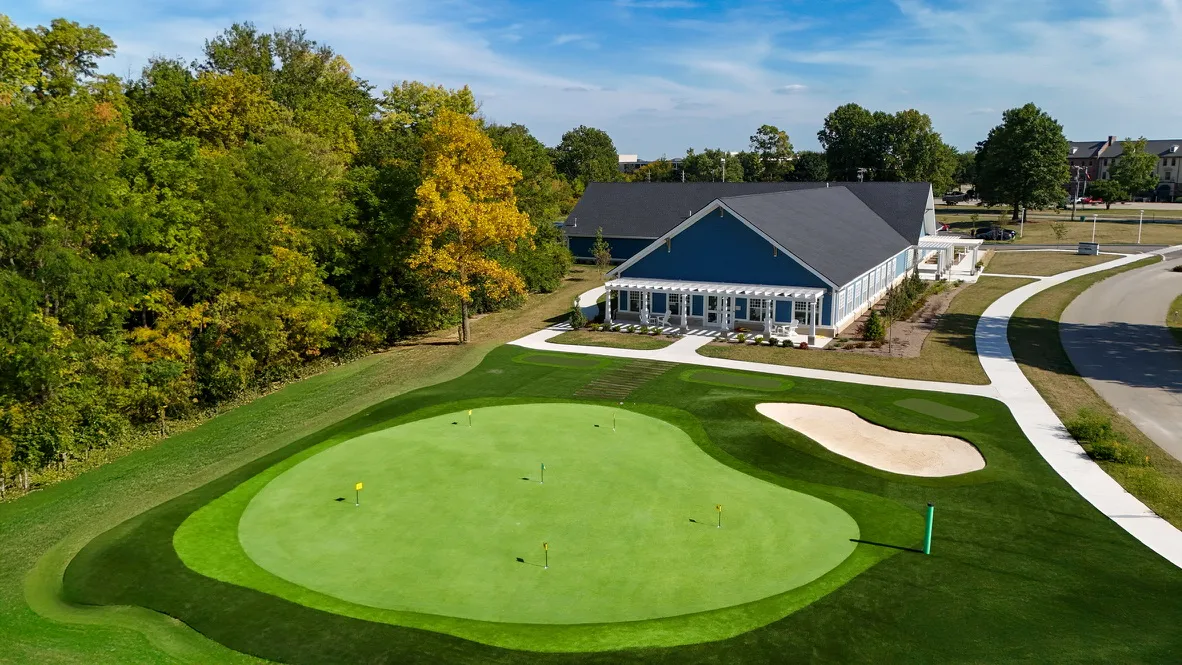 Pete and Alice Dye Indiana Golf Center synthetic putting green with practice bunker and clubhouse in Indiana