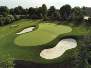 Custom Backyard Putting Green with Synthetic Turf and Stacked Sod Bunkers